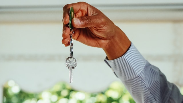 a hand holding a house key